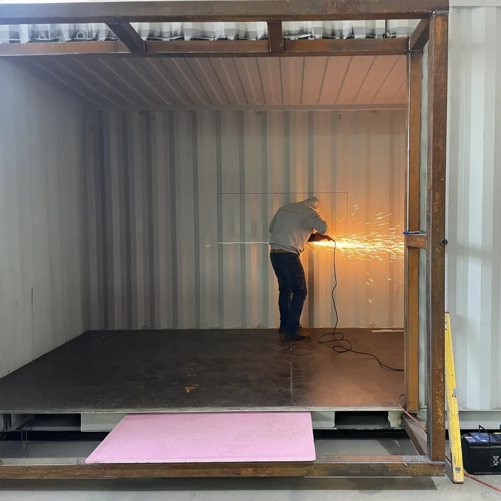 Container umbauen: gedämmter Seecontainer mit Fenster und Personentü